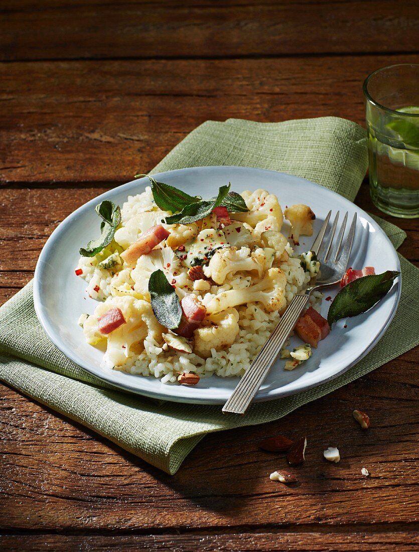 Almond risotto with cauliflower, sage, bacon and blue cheese served with lime water