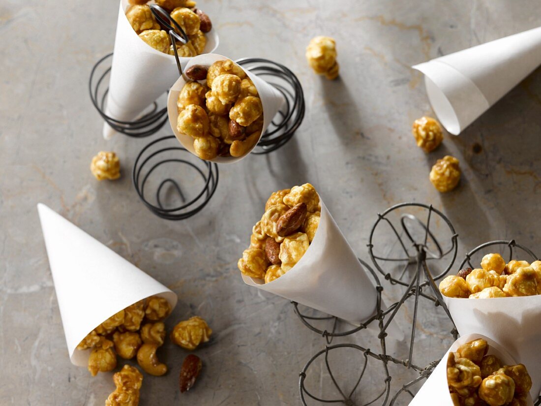 Caramel popcorn with almonds in paper cones