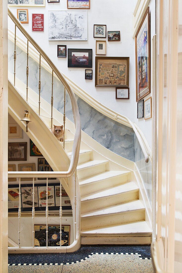 Staircase with cream wooden staircase and gallery of pictures on wall