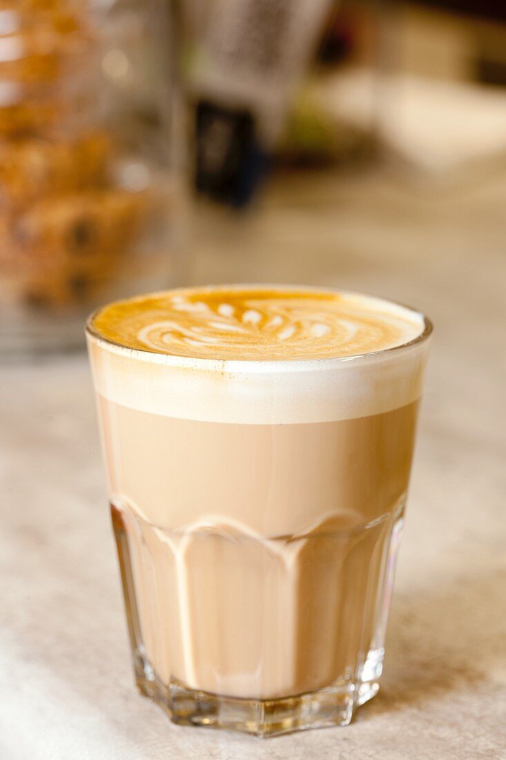 A glass of caffe latte with milk foam