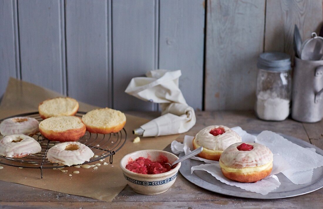 Raspberry jam doughnuts being made