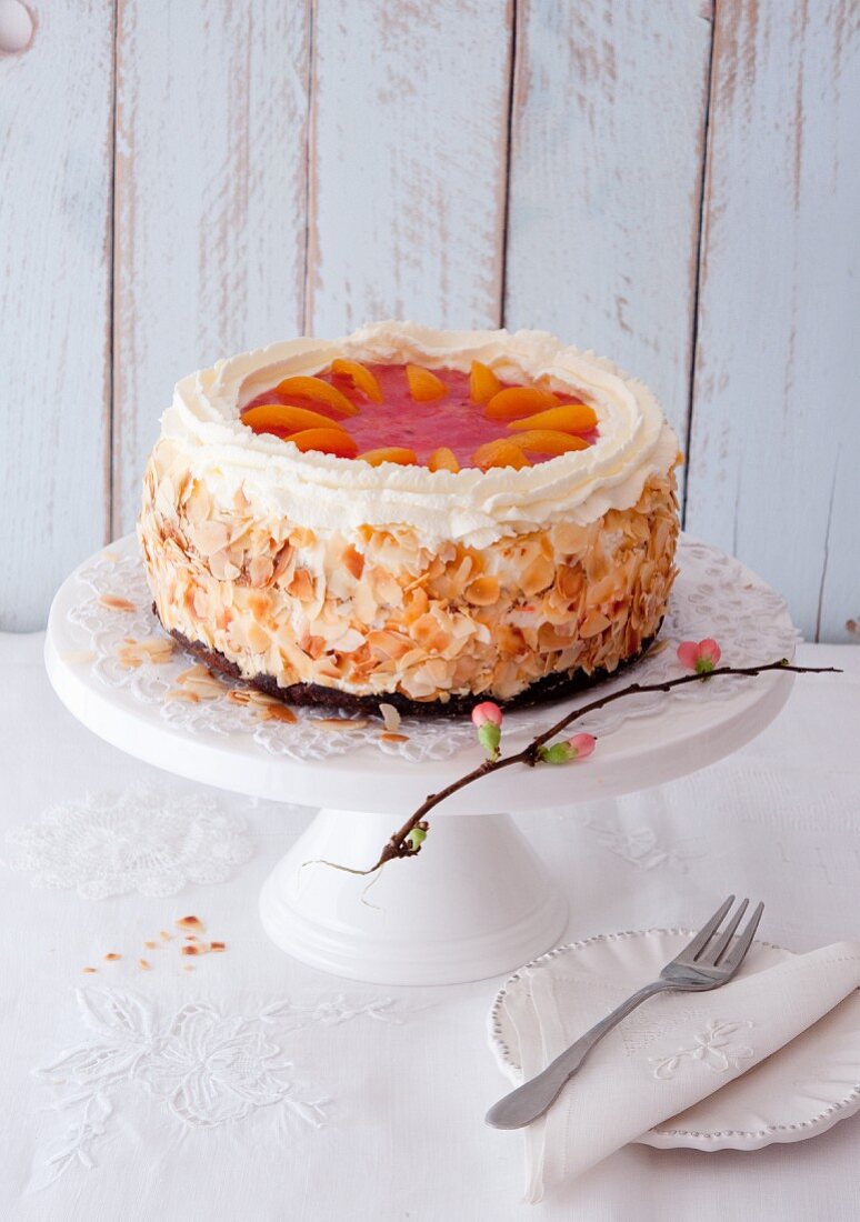 An apricot cream cake decorated with flaked almonds