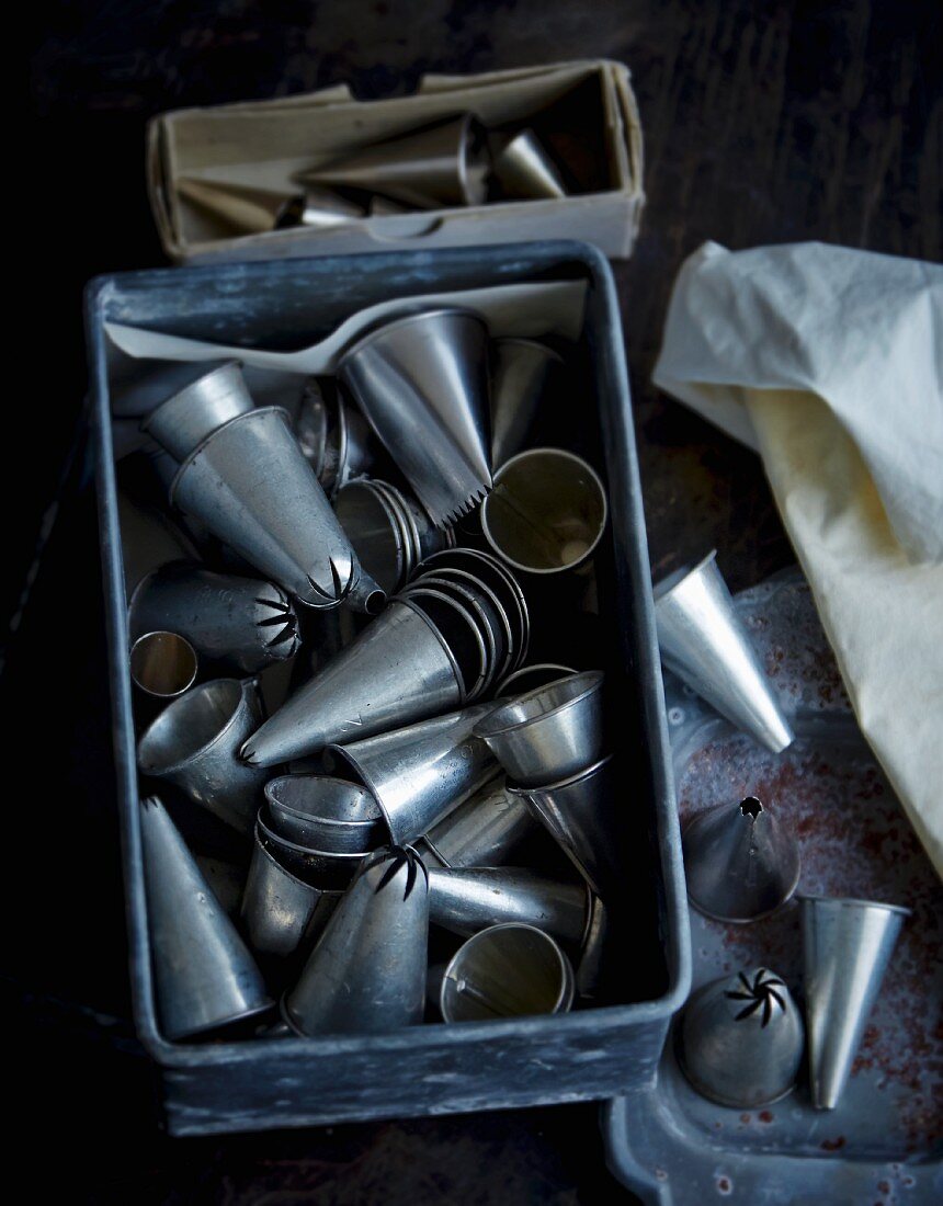 Various piping bag nozzles in a tin