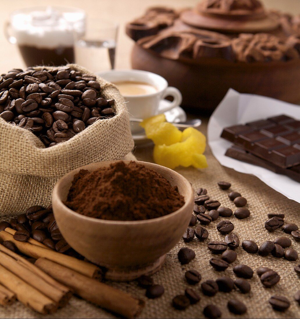 An arrangement of ground coffee, coffeebeans and chocolate