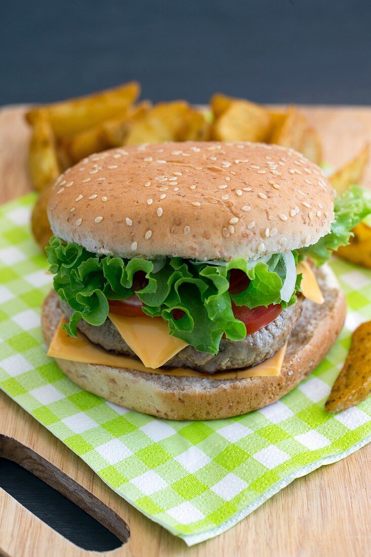 A cheeseburger with tomatoes and lettuce