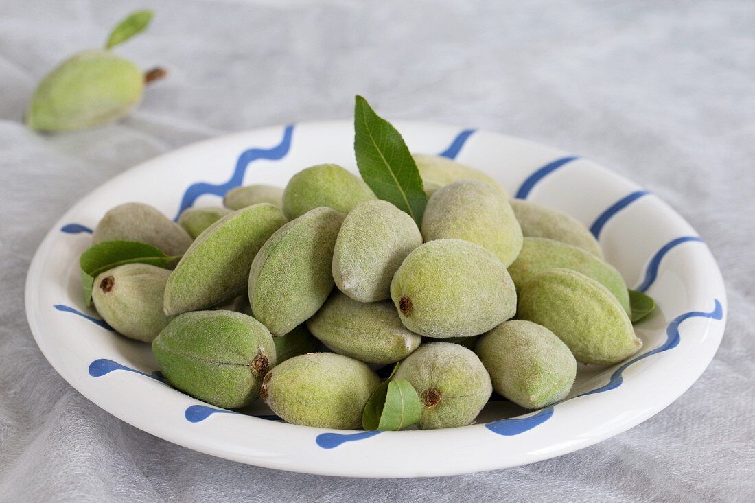 A plate of whole, fresh almonds
