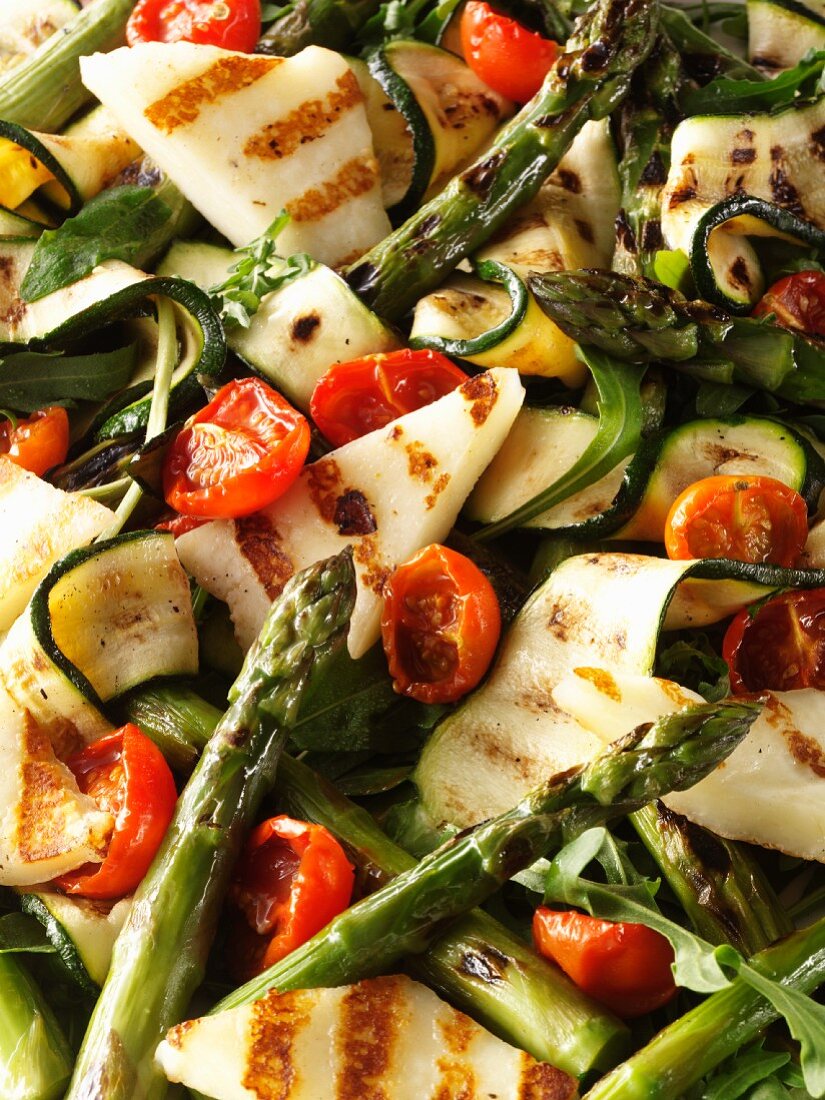 Courgette and asparagus salad with tomatoes and grilled cheese