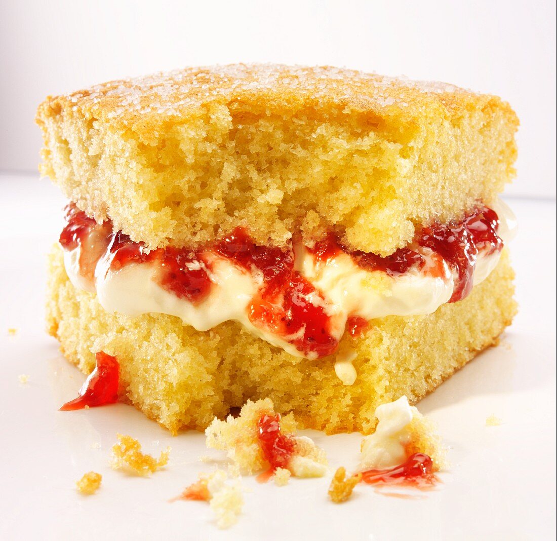 A slice of Victoria Sponge Cake with a bite take out