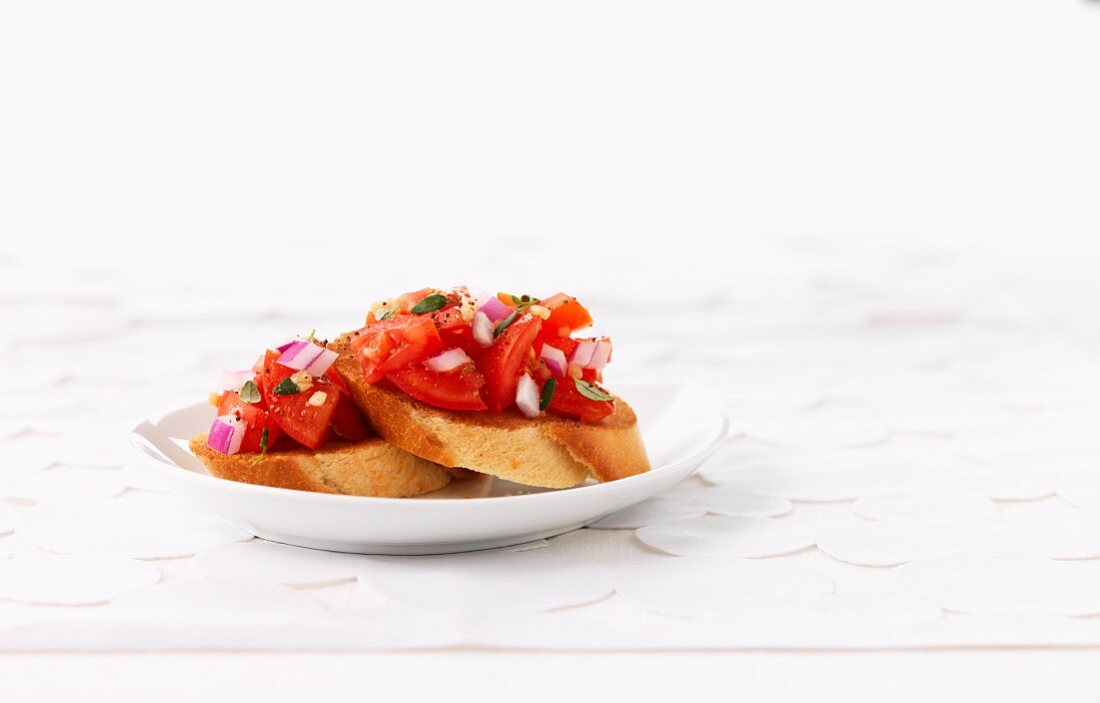 Bruschetta topped with tomatoes and onions