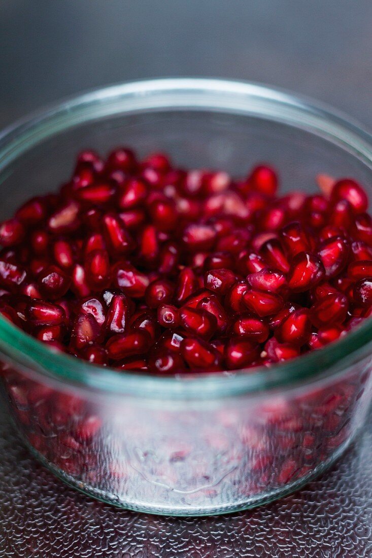 Pomegranate seeds in a glass jar