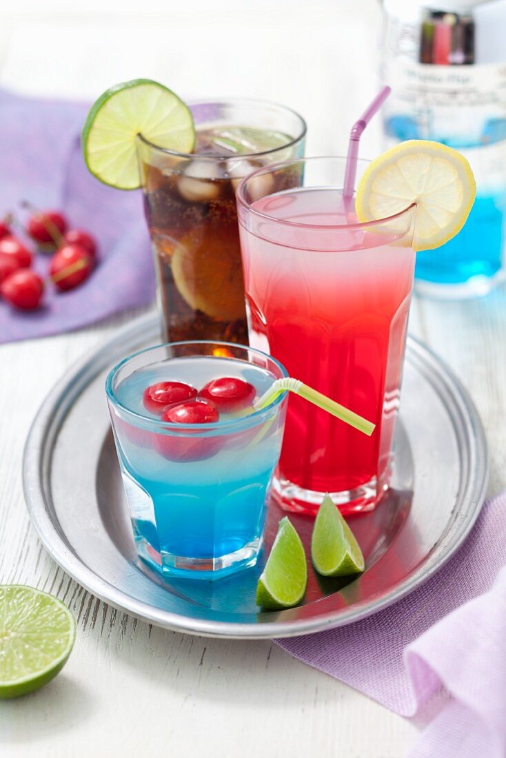 Colourful drinks with cherries, lemons and lime