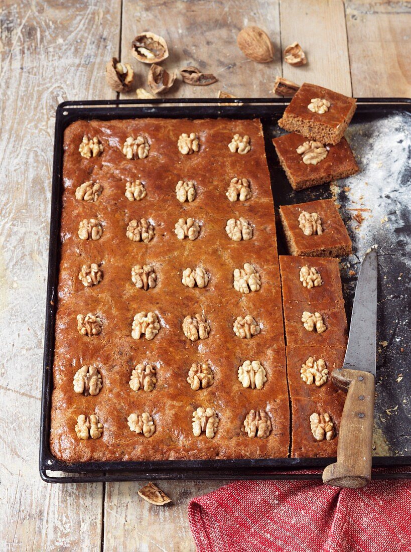 Gingerbread cake with walnuts on a baking tray