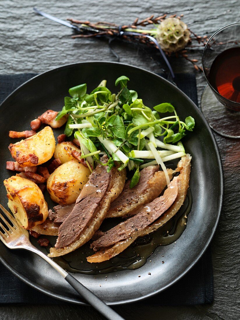 Goose with bacon potatoes in a white wine sauce served with a fresh salad with apple