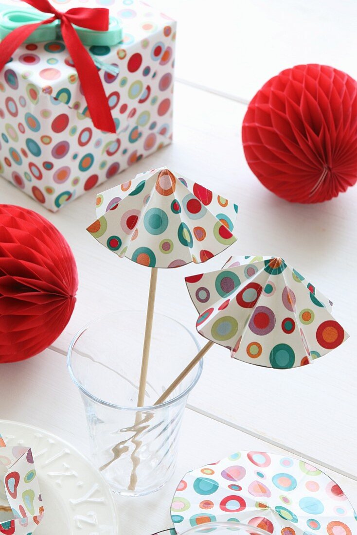 Hand-crafted paper cocktail umbrellas, honeycomb paper balls and wrapped present