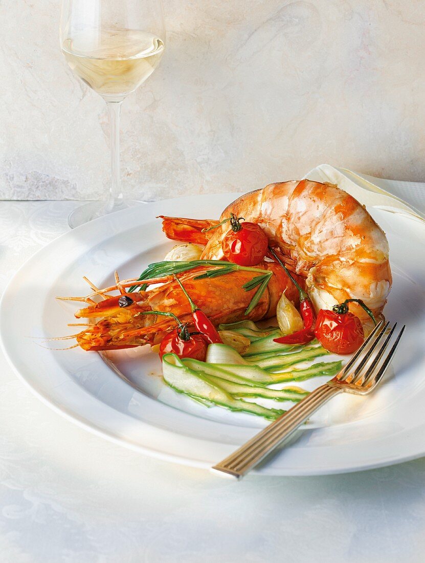 King prawns on a bed of green asparagus with melted cherry tomatoes
