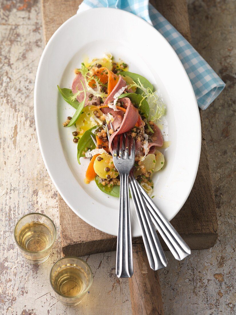 Veal tongue salad with potatoes and lentils