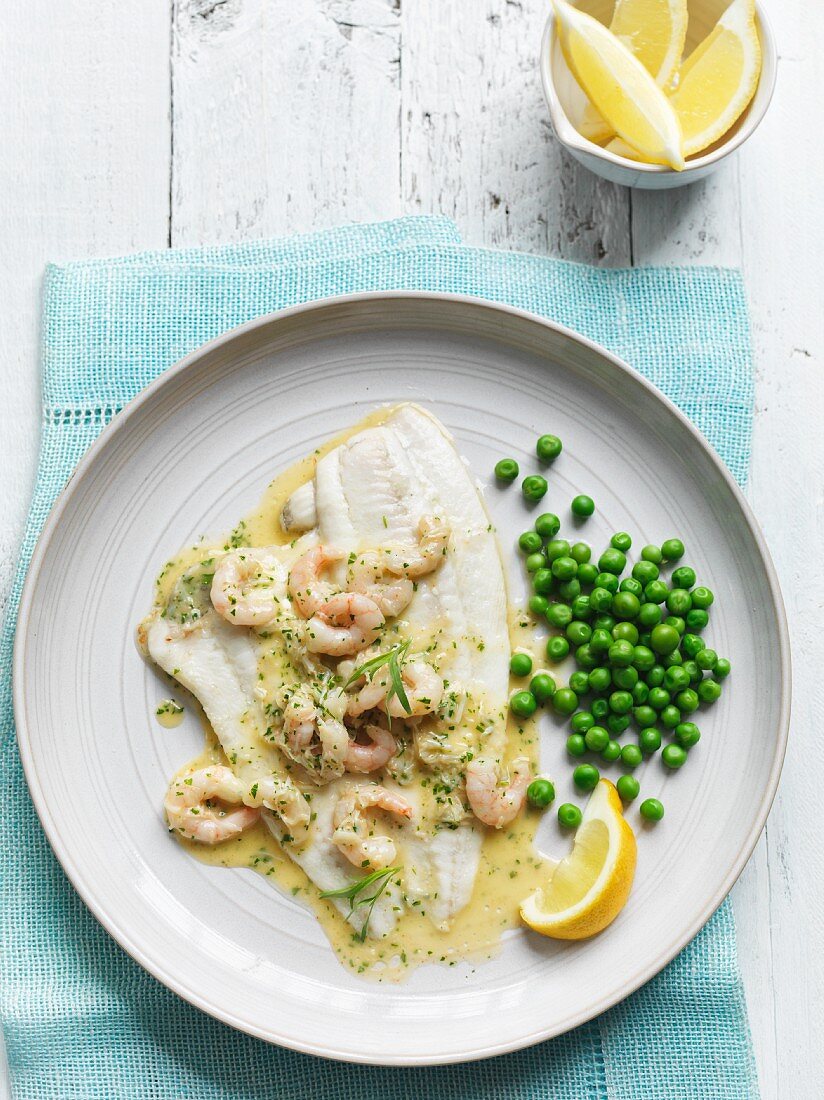 Plaice fillets with prawn in beurre blanc served with peas