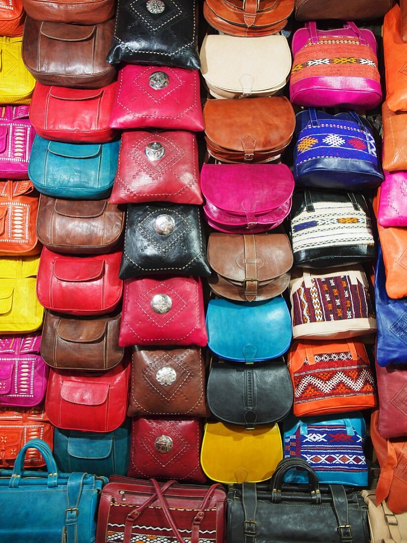 An arrangement of colourful leather handbags at a market in Fez, one of the four royal cities in Morocco