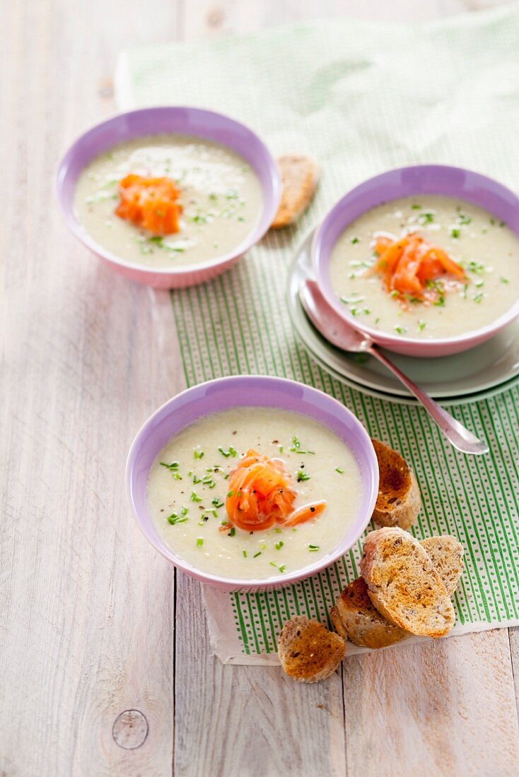 Cream of asparagus soup with smoked salmon and grilled bread