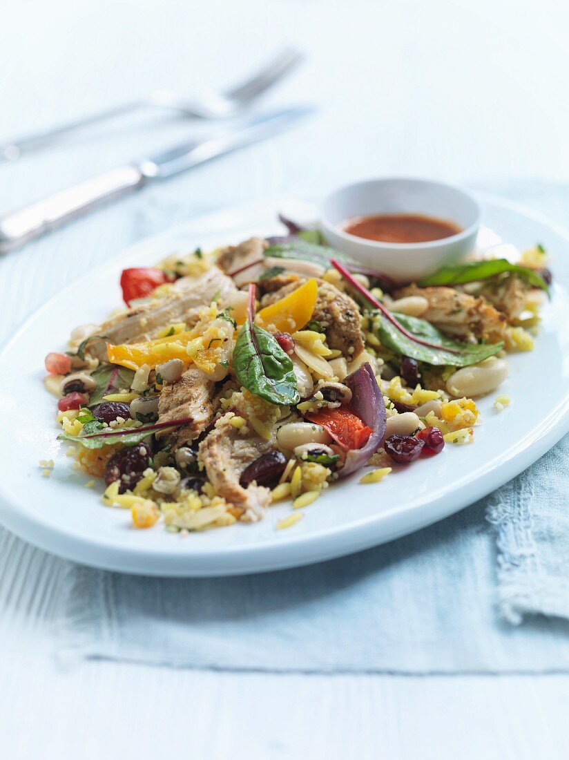 Mediterranean chicken salad with roast vegetables, olives and beans