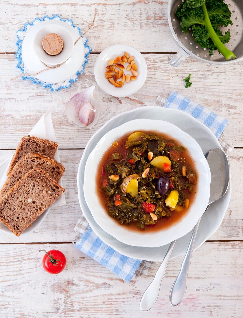 Green kale soup from Portugal with bread and pine nuts