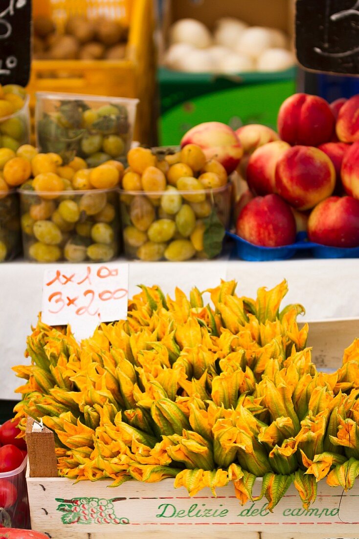 Courgette flowers, grapes and nectarines at a market