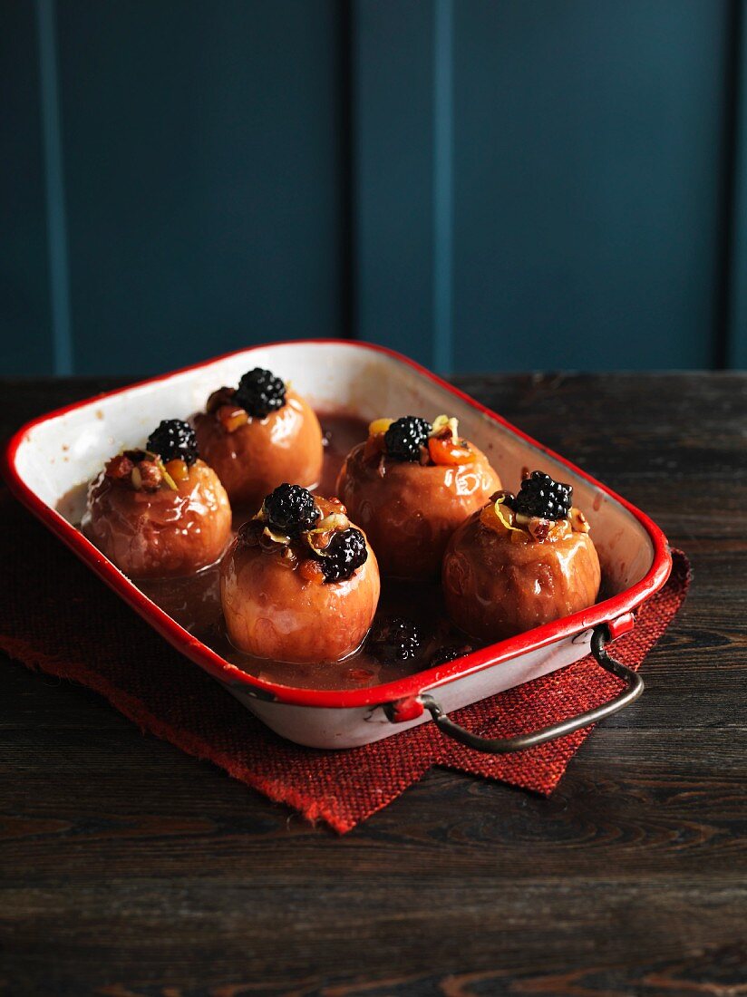 Baked apples with fruit and nuts in a baking dish