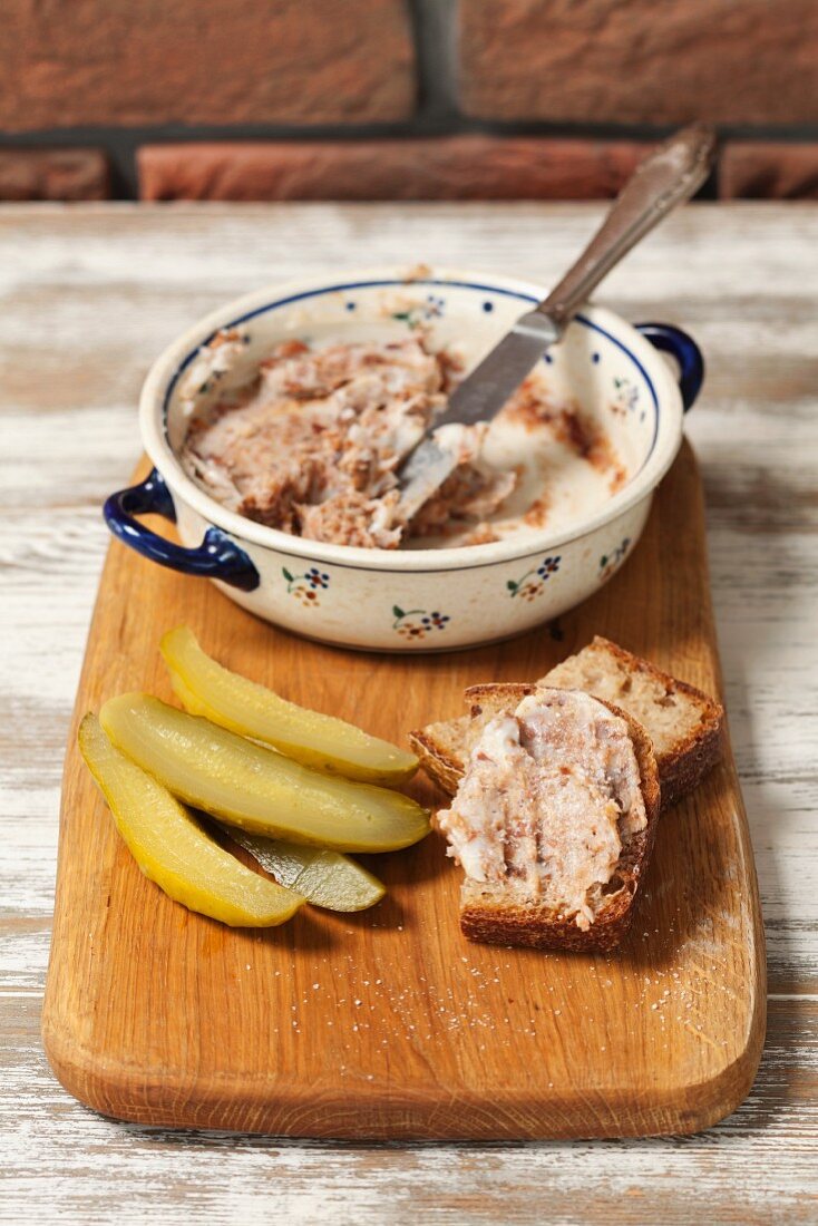 Pork dripping with homemade bread and gherkins