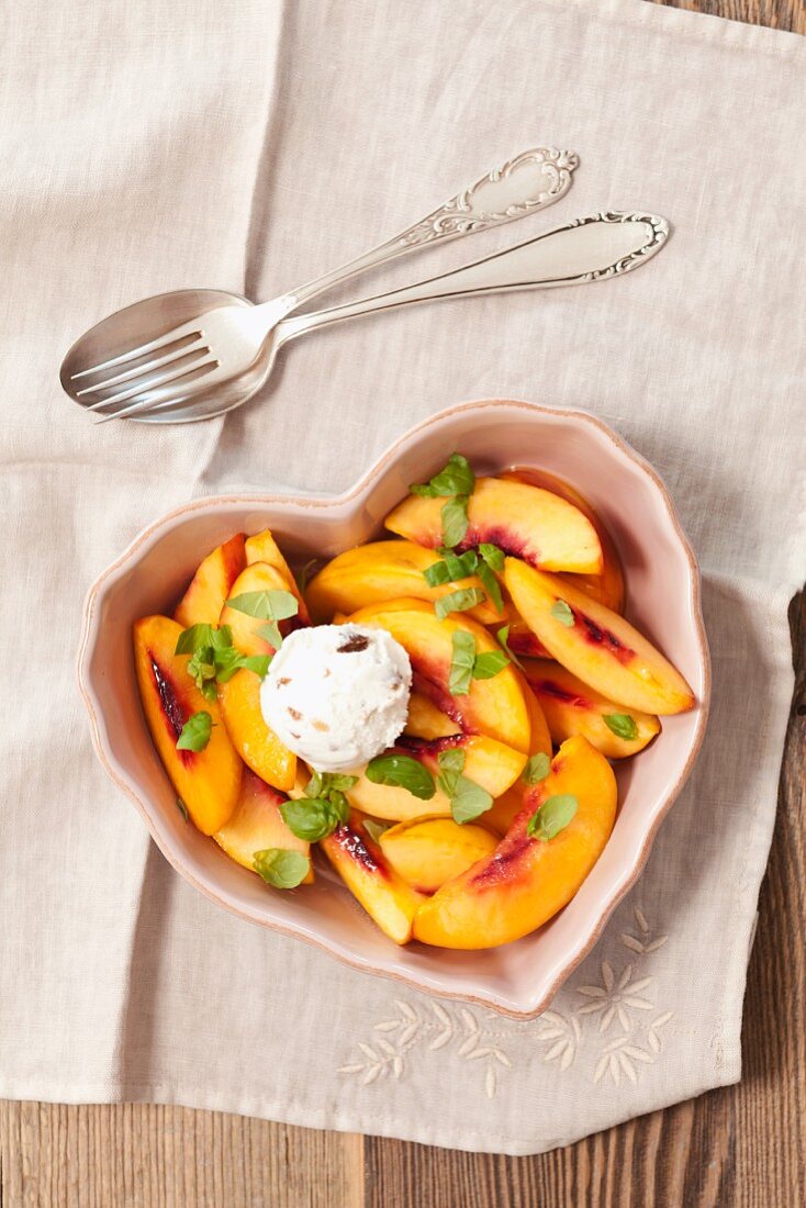 Nectarines fried in butter with honey, basil and ice cream