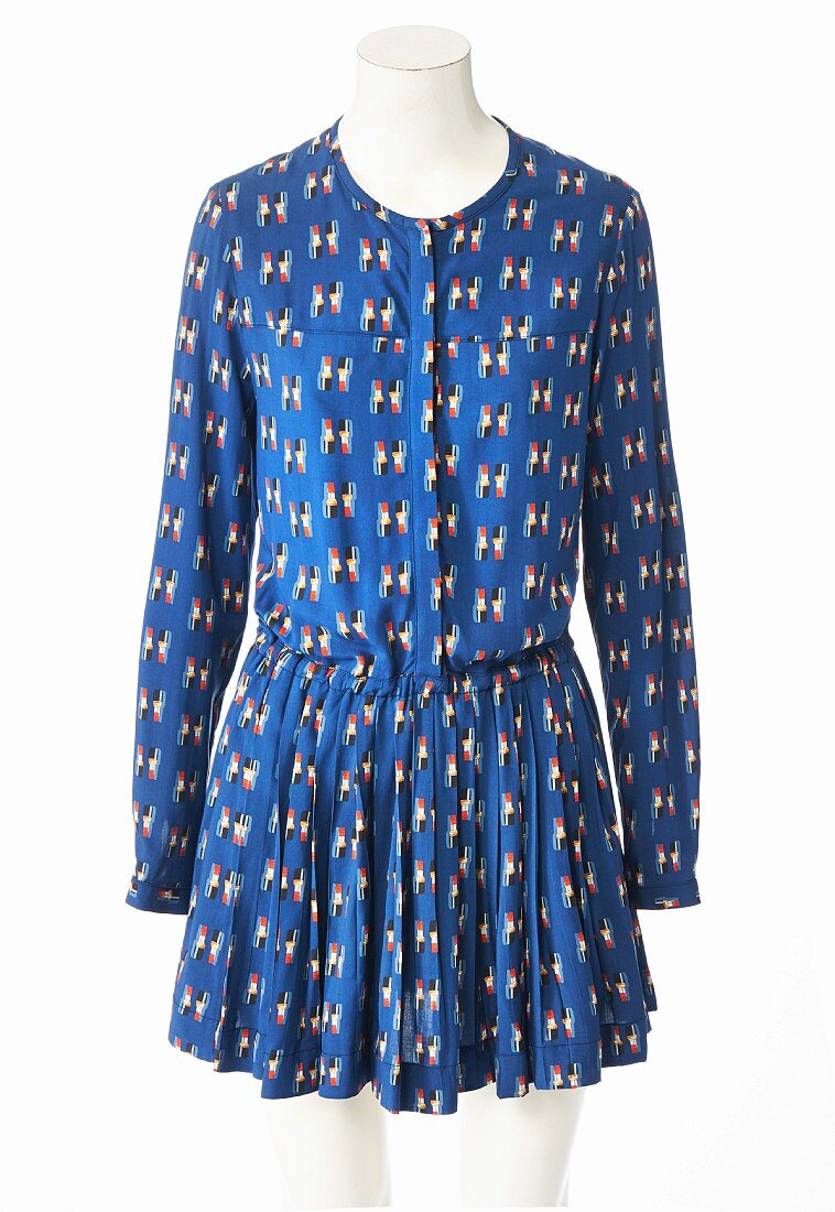 A blue patterned minidress with long sleeves and a pleated skirt