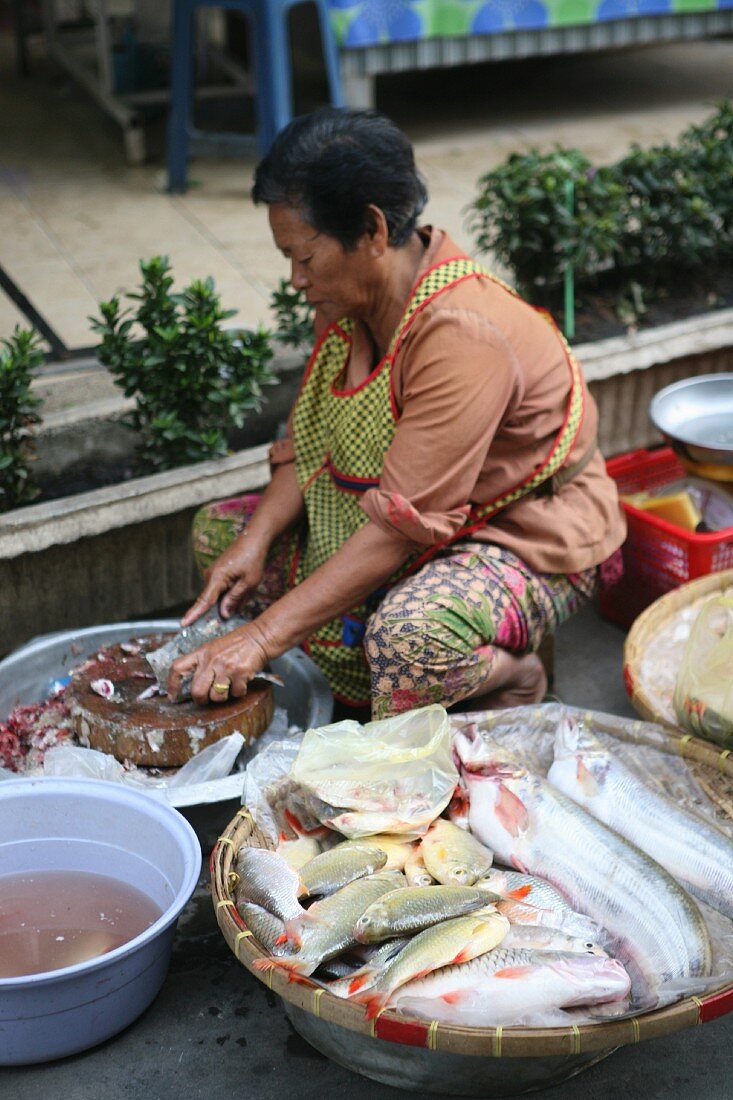 Fish being prepared for sale at a market in Thailand