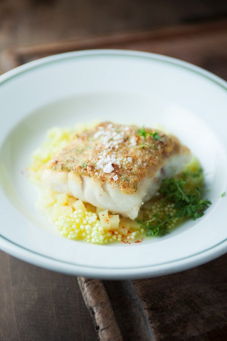 Cod with a roast onion crust on a bed of potato risotto