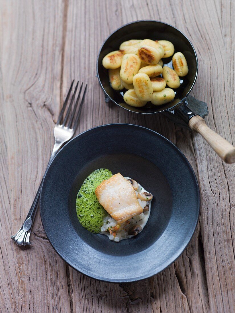 Sheatfish with a kohlrabi and mushroom sauce served with potato gnocchi