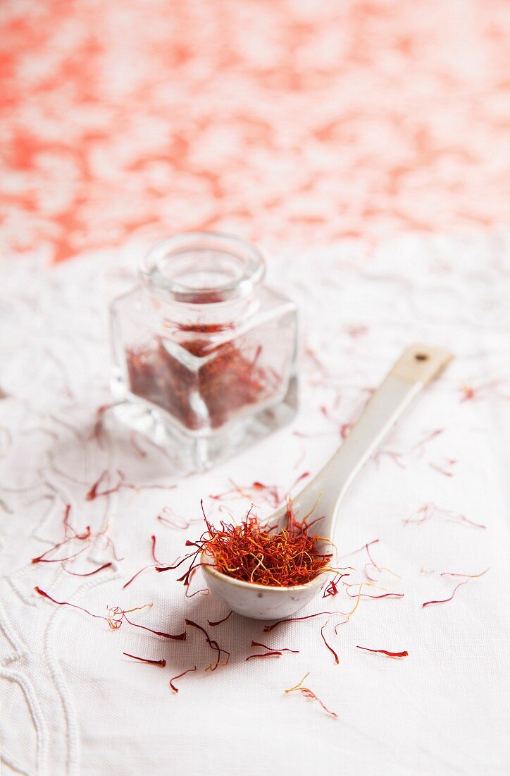 Saffron threads on a spoon and in a jar
