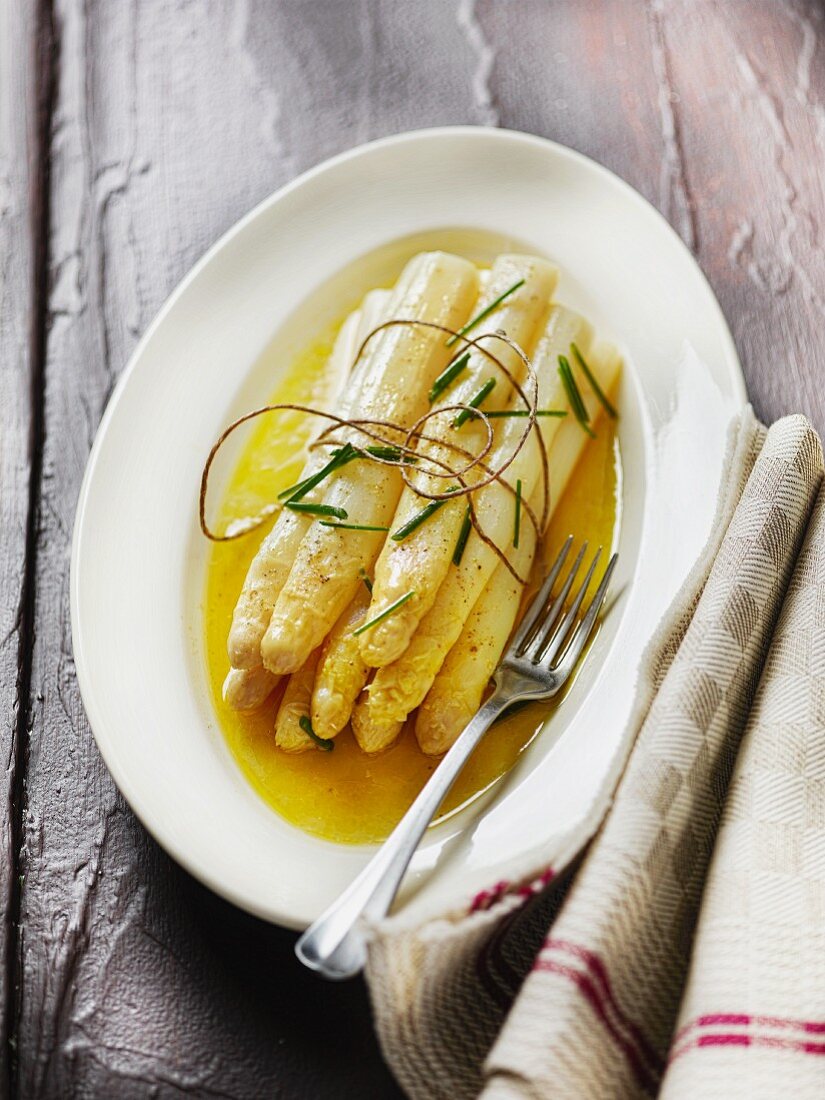 Cooked white asparagus with melted butter
