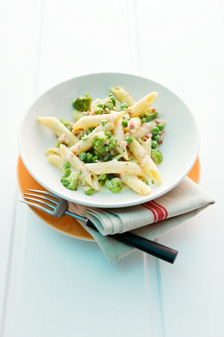 Penne alla carbonara with broccoli and peas