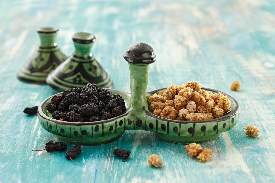 Dried mulberries in ceramic dishes
