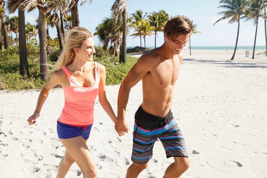 A young couple walking on a beach