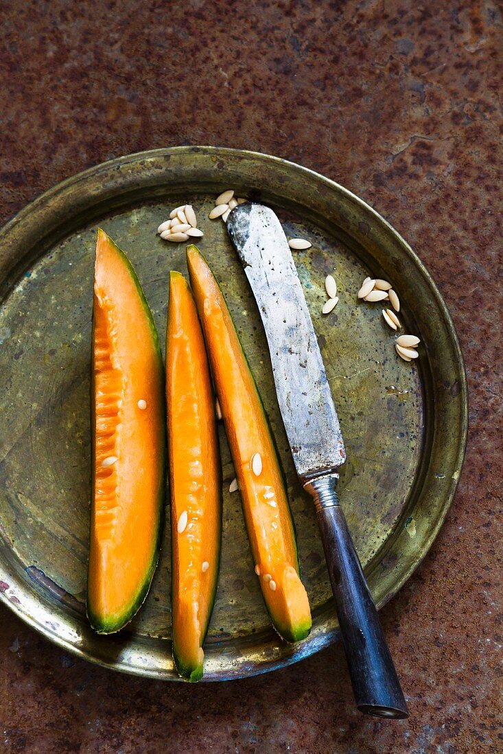 Melon wedges on a vintage metal plate