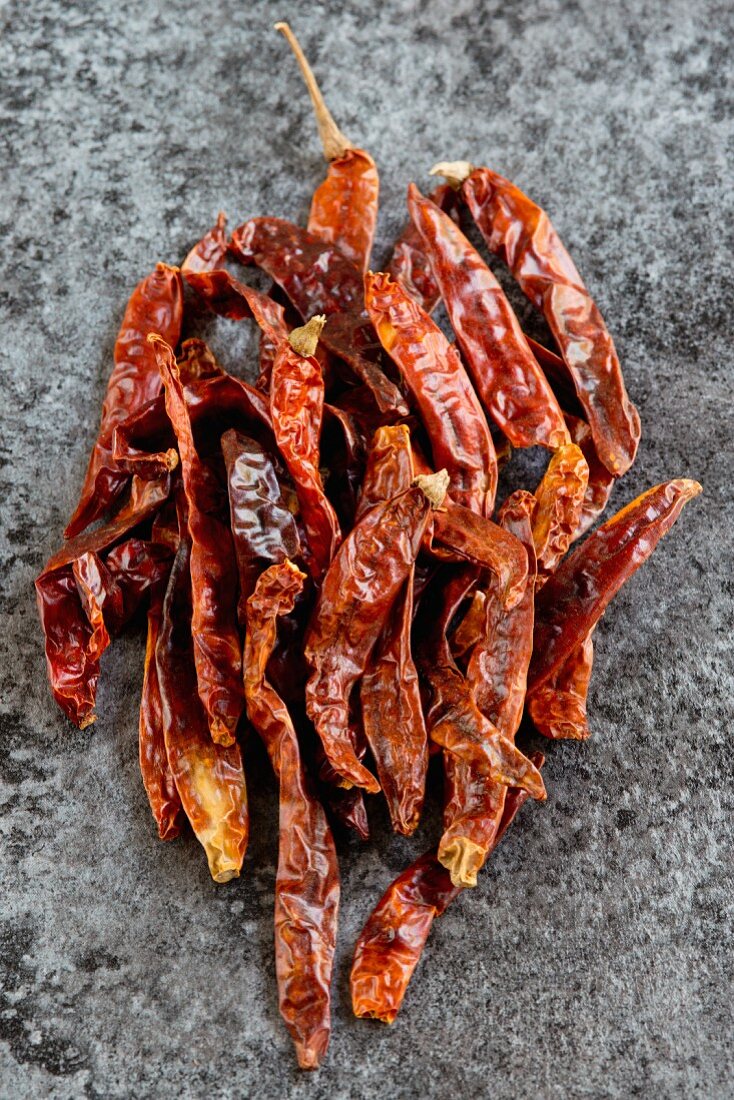 Dried chilli peppers on a stone surface