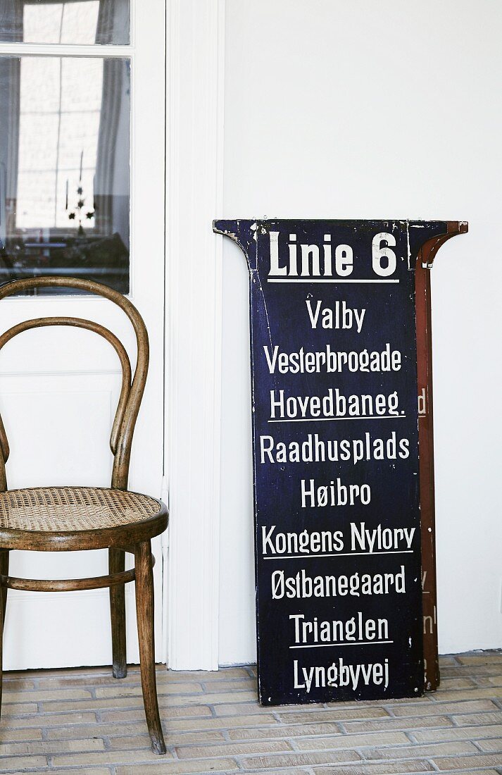 Thonet Bugholzstuhl neben Vintage Tramschild mit dänischen Haltestationen