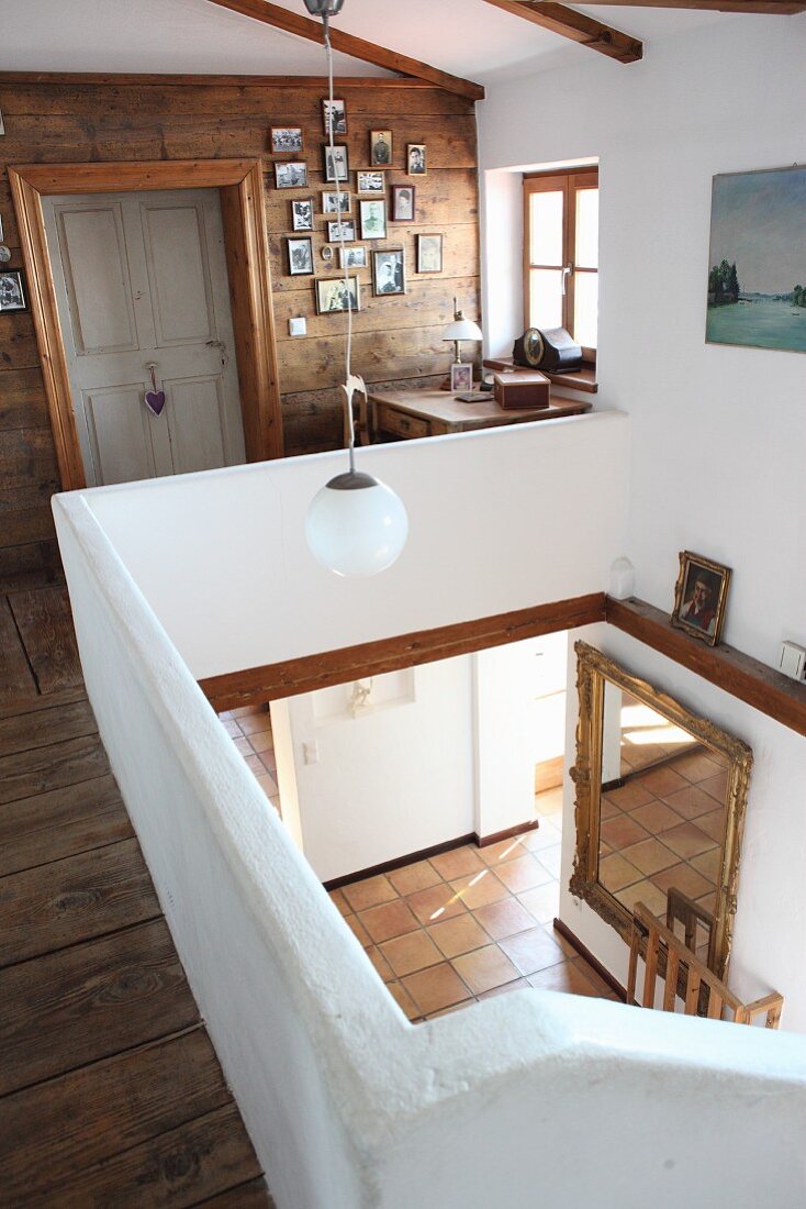 Landing with view down into foyer of renovated farmhouse