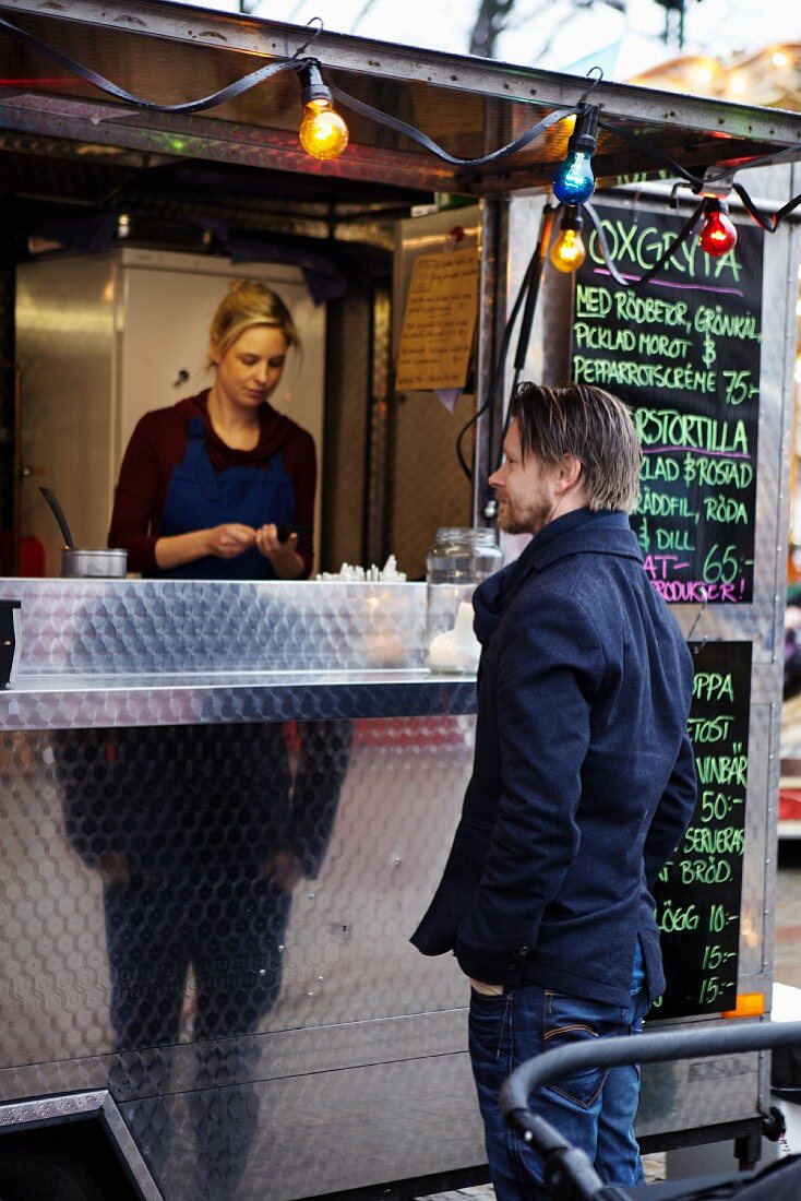 A man being served at a mobile food unit