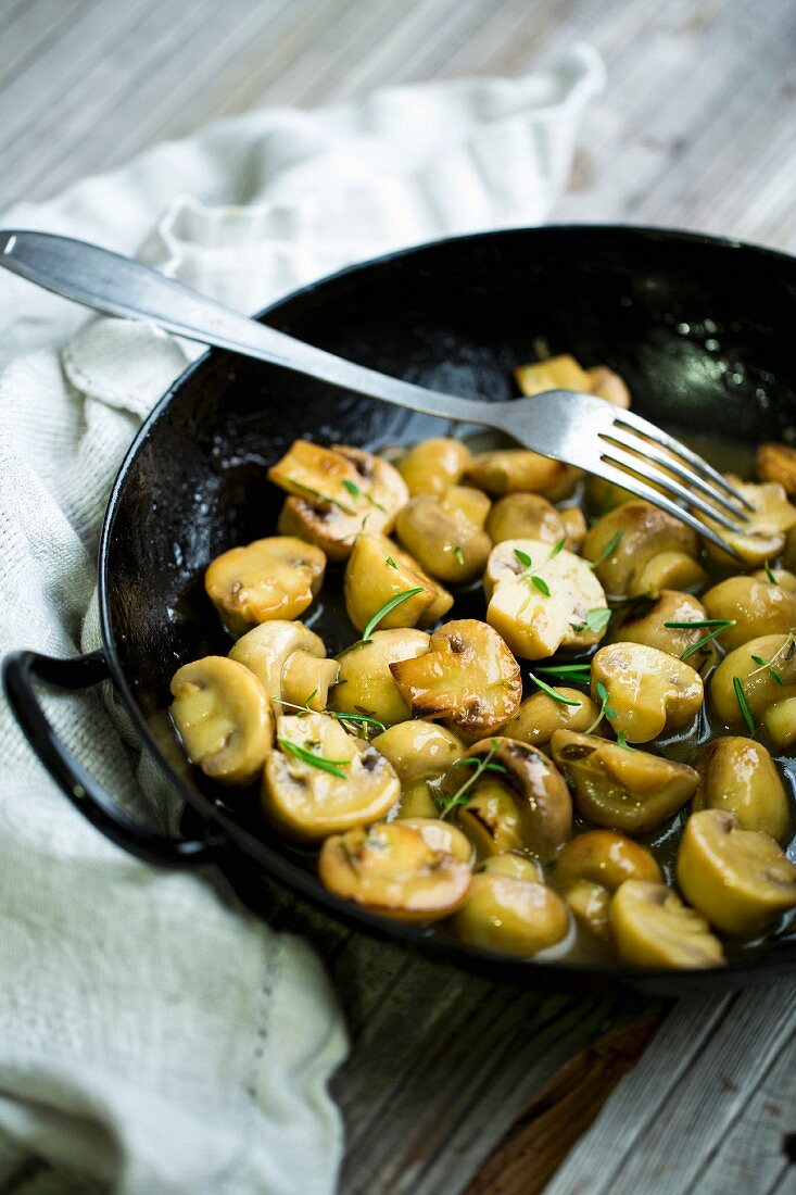 Fried mushrooms with olive oil, herbs and white wine
