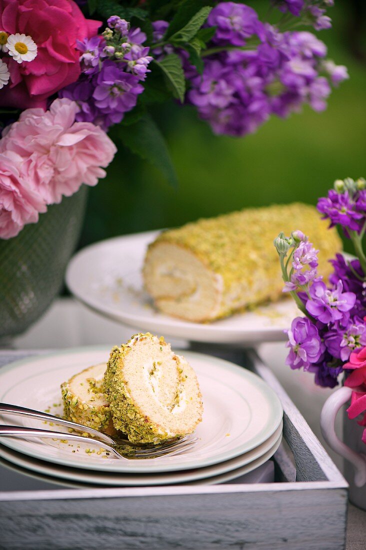 Swiss roll with pistachios and rose water on a cake buffet