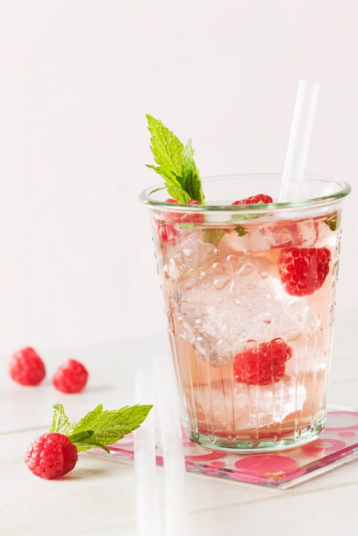 Raspberry lemonade with ice cubes and mint