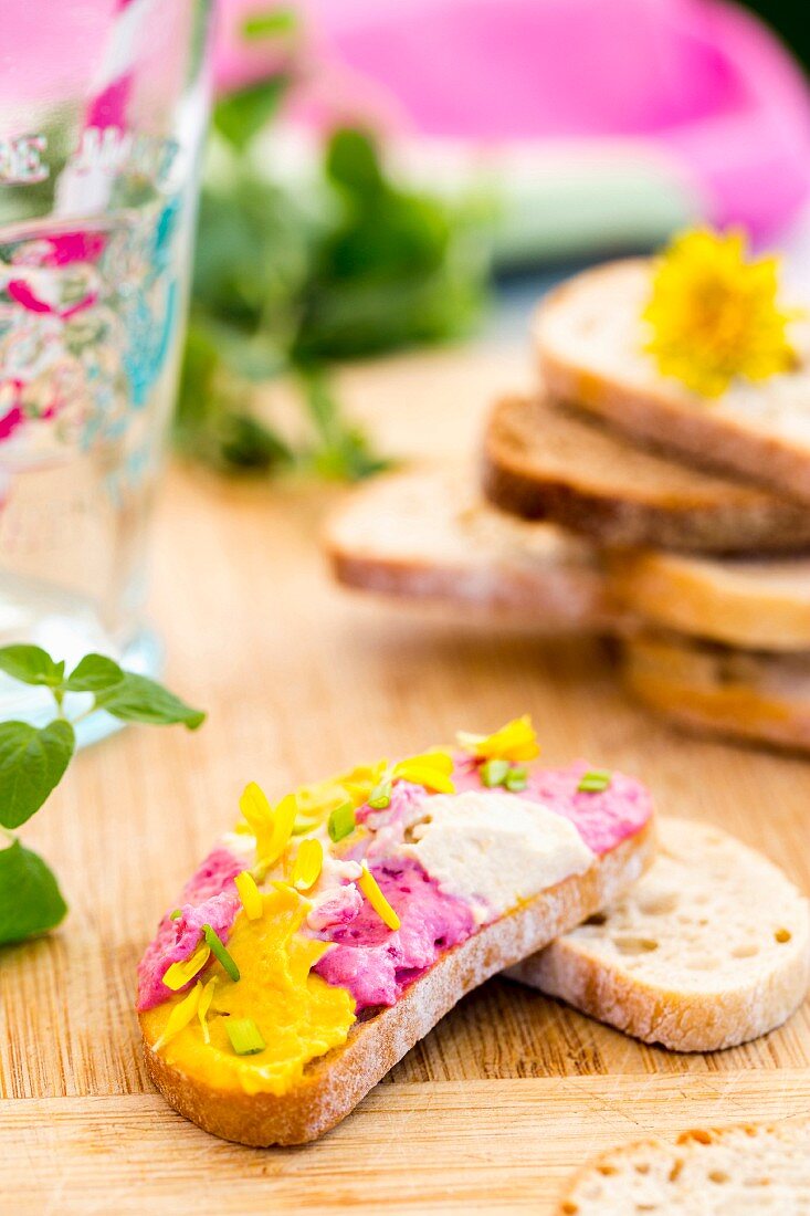 Belegtes Brot mit Hummus, Ringelblumenblüten und Zwiebeln