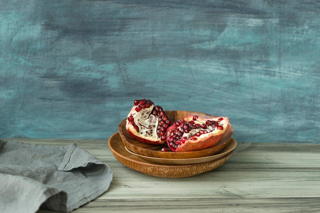 Pieces of pomegranate in a wooden dish