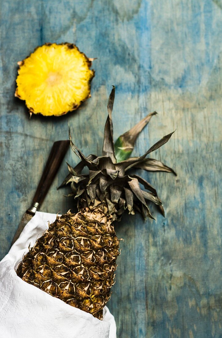 Sliced pineapple on a blue wooden surface