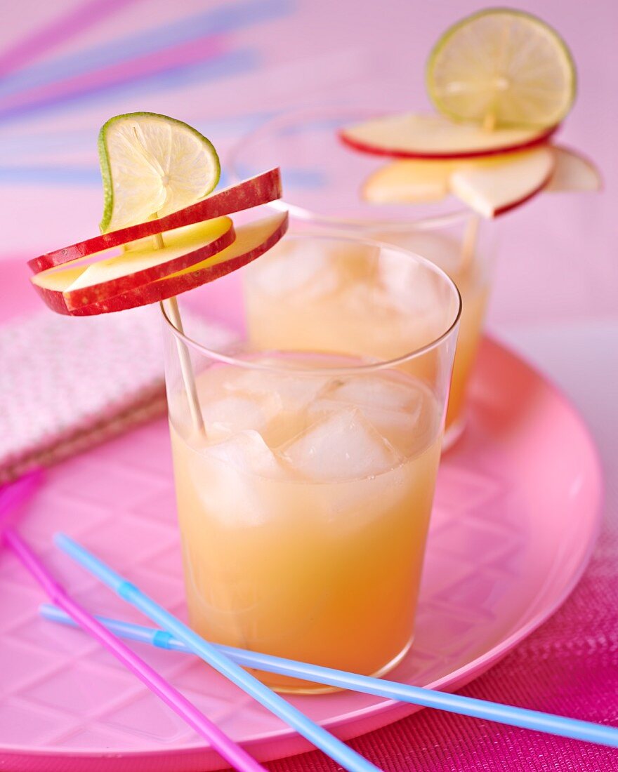 A fitness drink made with apples and limes with ice cubes